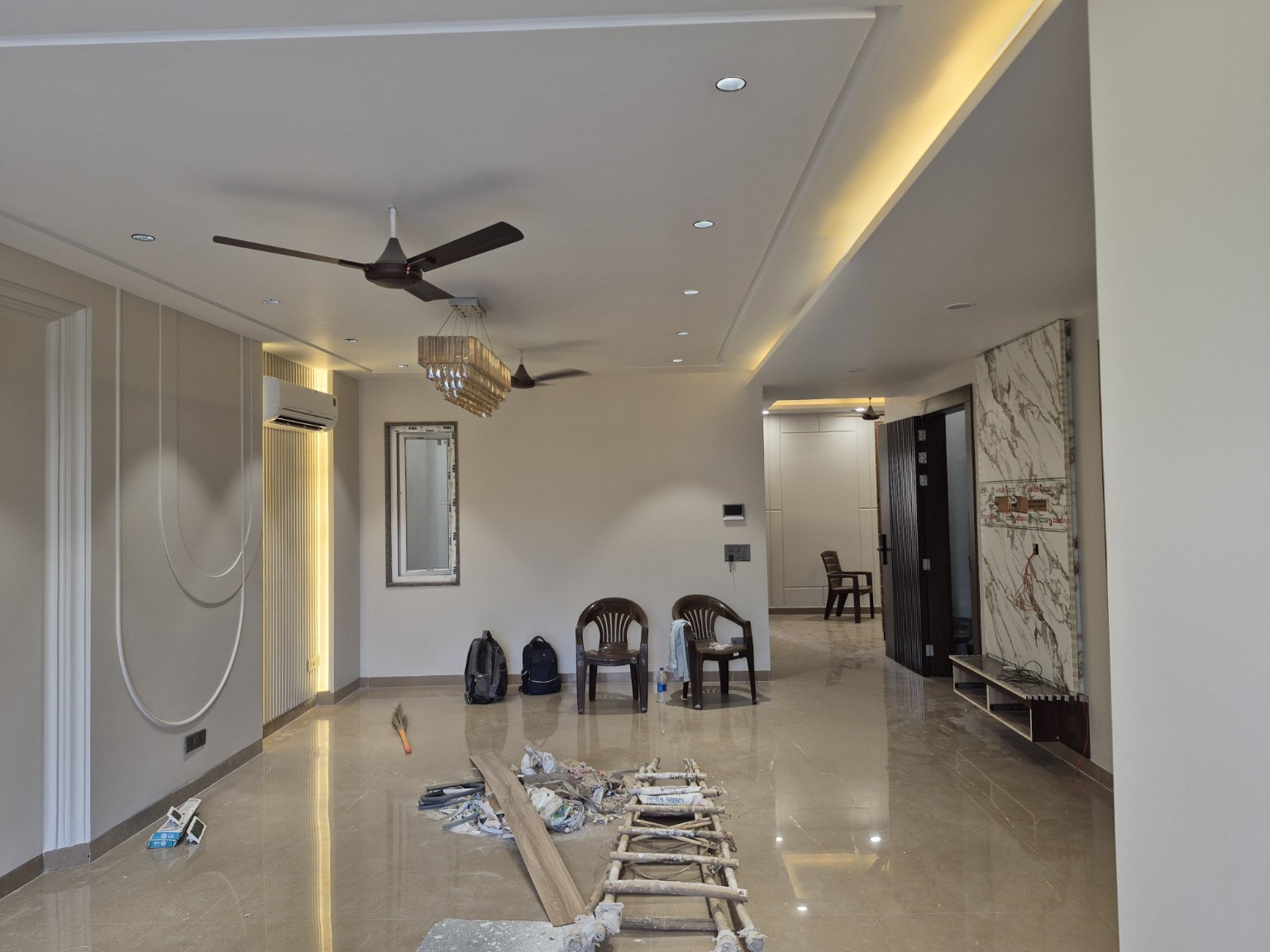Living-area ceiling, wall finishes and work equipment at Sector 23, Gurugram — work ongoing