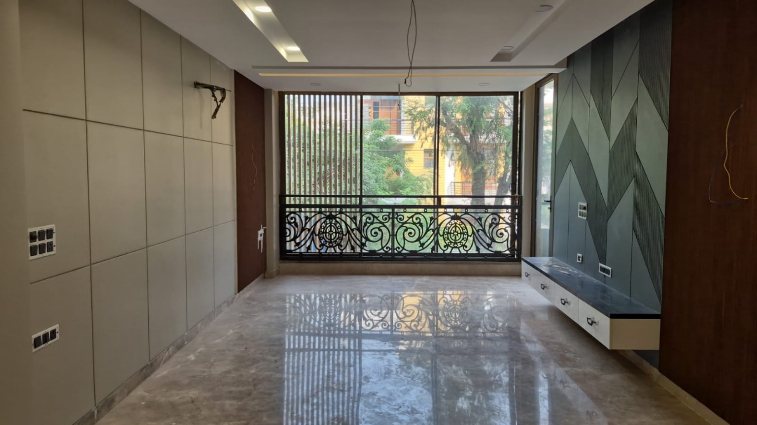 Room with geometric feature wall and floating cabinet at C1, Palam Vihar — work ongoing